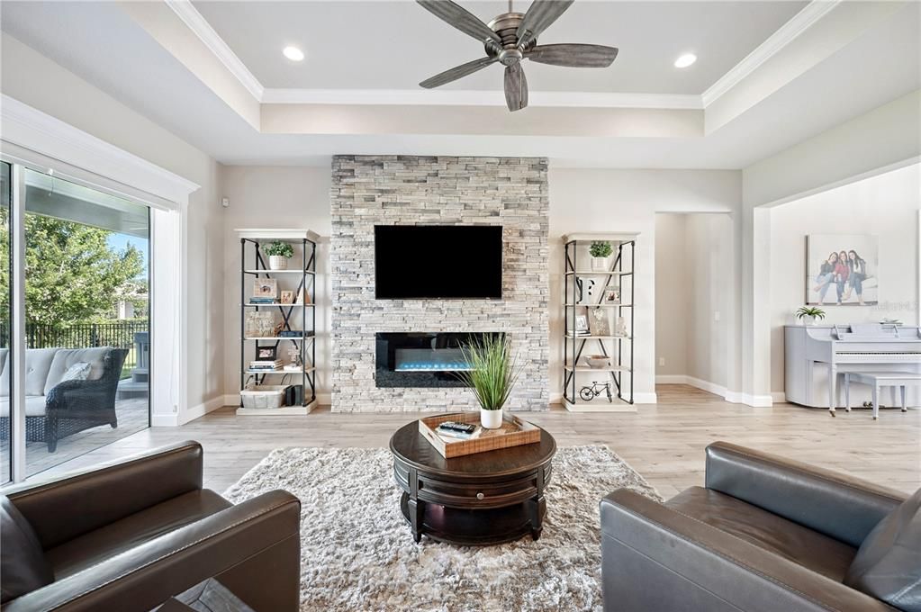 Fireplace, Interior, Living room, Piano, Recessed Lighting, Stone Walls, Wood Texture Flooring