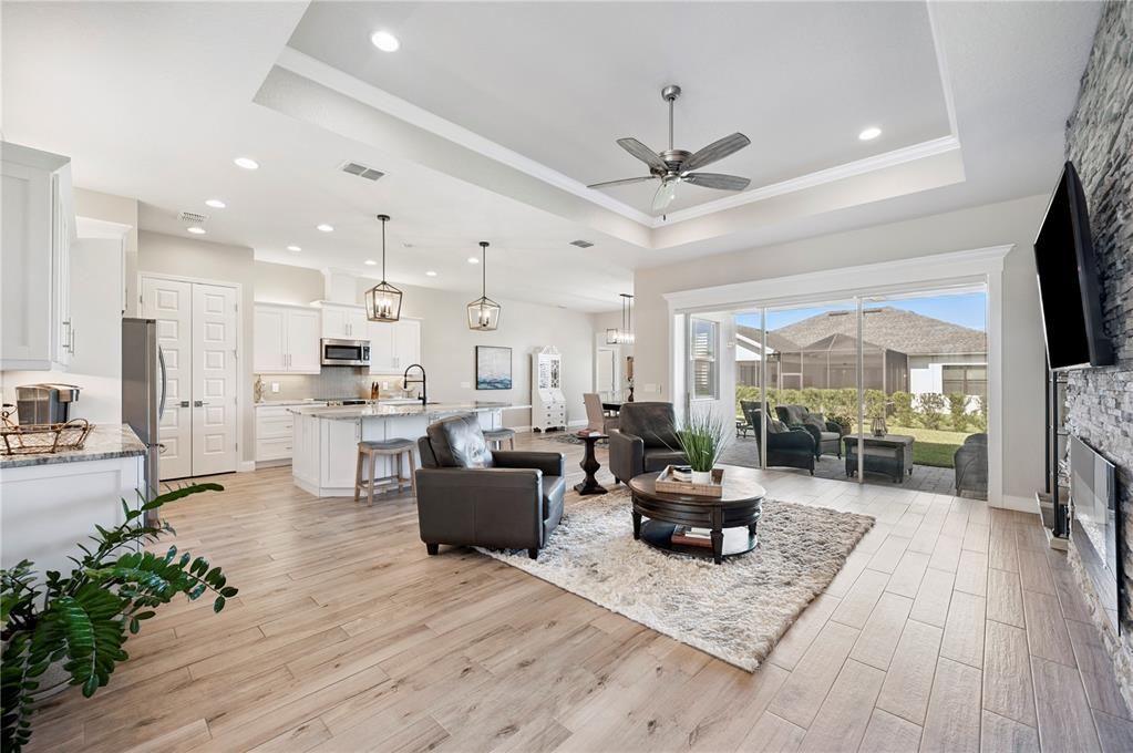 Fireplace, Interior, Kitchen, Living room, Pendant Lights, Recessed Lighting, Stainless Steel Appliances, Wood Texture Flooring