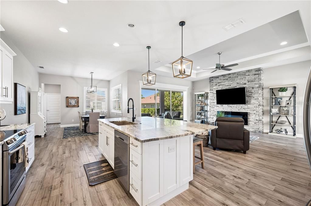 Dining room, Fireplace, Interior, Kitchen, Pendant Lights, Recessed Lighting, Stainless Steel Appliances, Stone Walls, Wood Texture Flooring