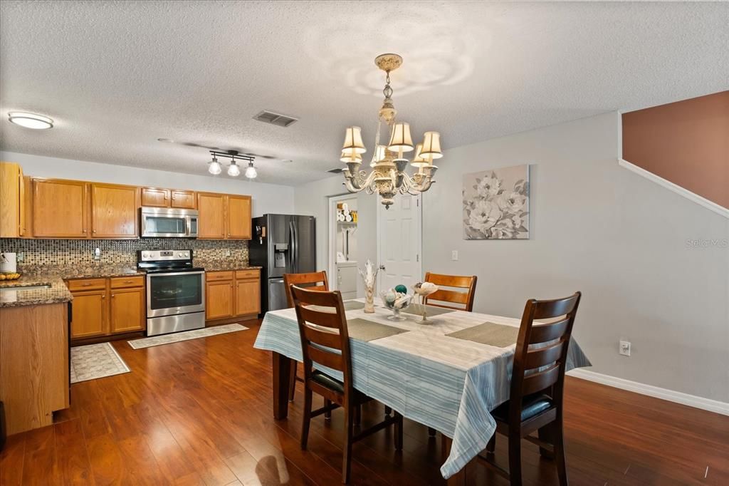 Chandelier, Dining room, Interior, Kitchen, Stainless Steel Appliances, Wood Texture Flooring