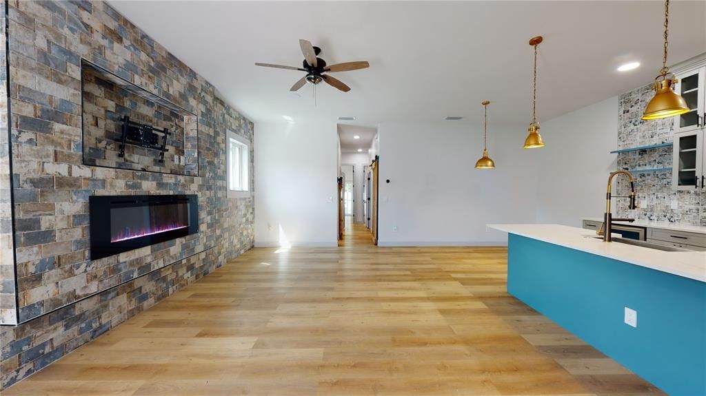 Empty room, Fireplace, Interior, Kitchen, Pendant Lights, Recessed Lighting, Stone Walls, Wood Texture Flooring