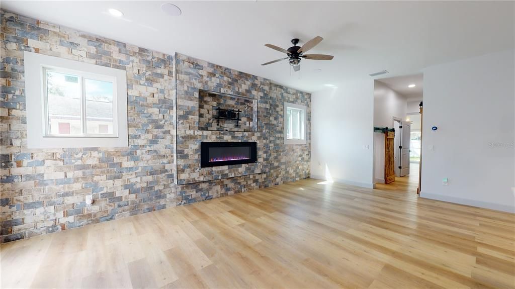 Empty room, Fireplace, Interior, Recessed Lighting, Stone Walls, Wood Texture Flooring