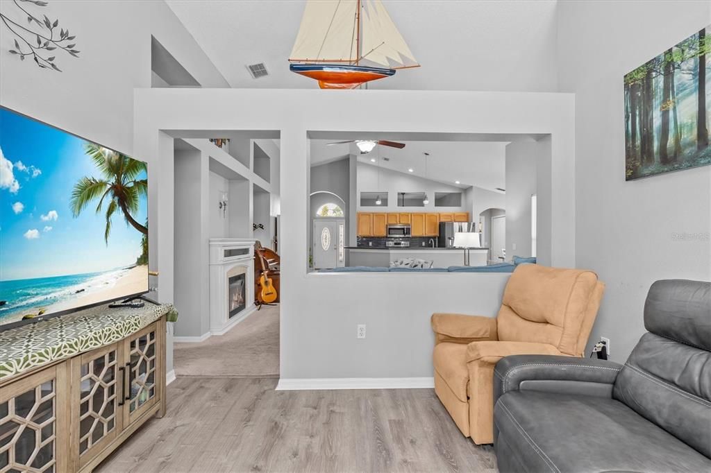 Fireplace, Interior, Kitchen, Pendant Lights, Recessed Lighting, Stainless Steel Appliances, Water, Wood Texture Flooring