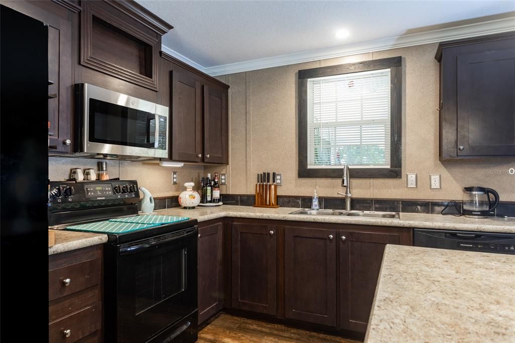 Interior, Kitchen, Recessed Lighting, Stainless Steel Appliances, Tile Countertops, Wood Texture Flooring