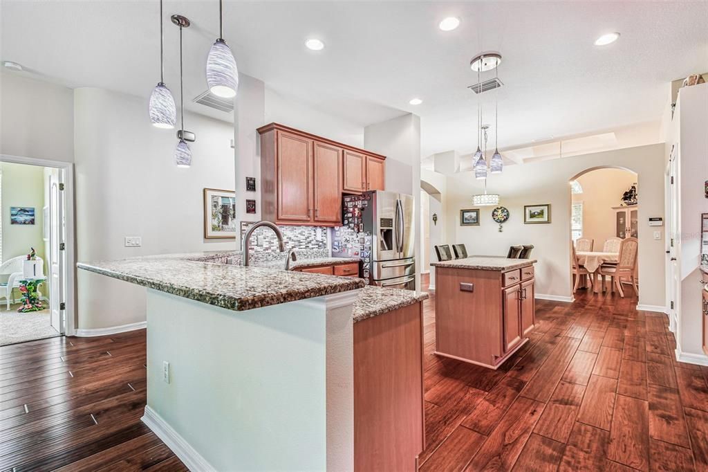 Dining room, Interior, Kitchen, Pendant Lights, Recessed Lighting, Stainless Steel Appliances, Wood Texture Flooring