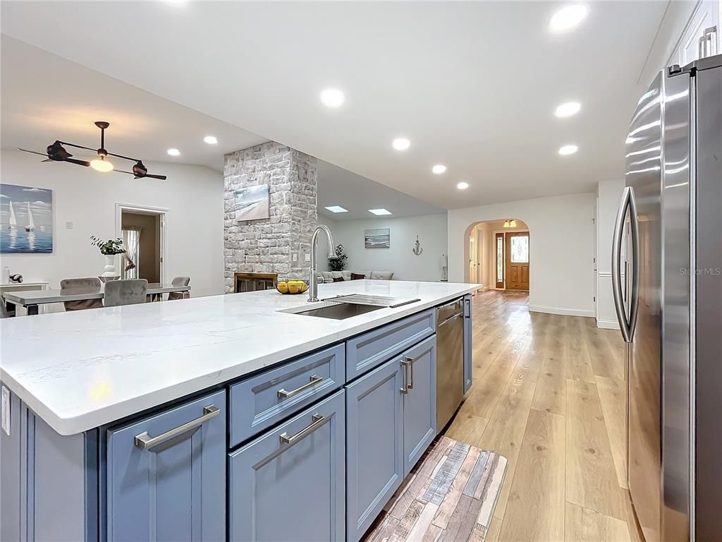 Dining room, Fireplace, Interior, Kitchen, Recessed Lighting, Stainless Steel Appliances, Stone Walls, Wood Texture Flooring