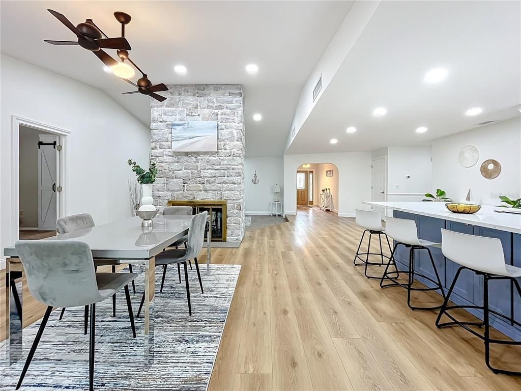 Dining room, Fireplace, Interior, Recessed Lighting, Stone Walls, Wood Texture Flooring