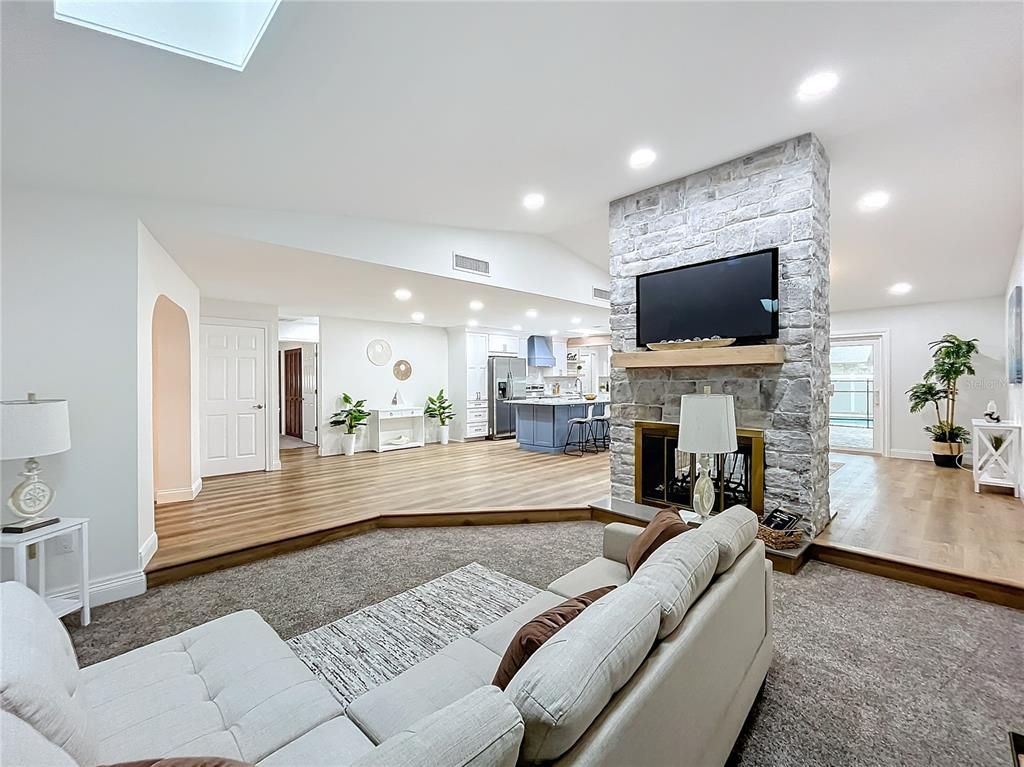 Fireplace, Interior, Living room, Recessed Lighting, Stone Walls, Wood Texture Flooring