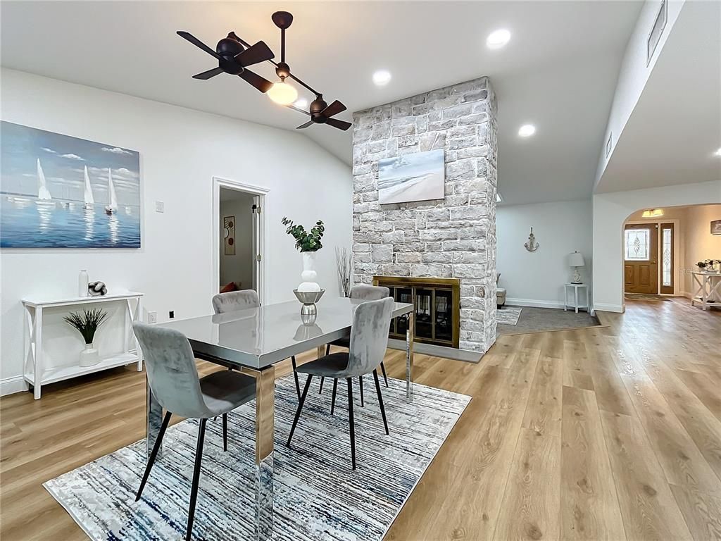 Dining room, Fireplace, Interior, Recessed Lighting, Stone Walls, Wood Texture Flooring