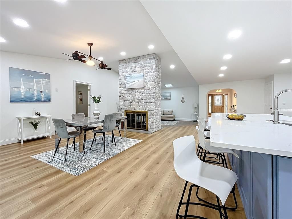 Dining room, Fireplace, Interior, Kitchen, Recessed Lighting, Stone Walls, Wood Texture Flooring