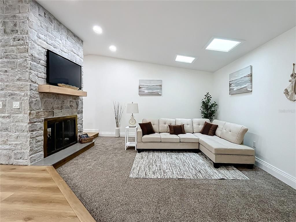 Fireplace, Interior, Living room, Recessed Lighting, Stone Walls, Wood Texture Flooring