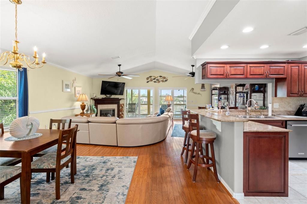 Chandelier, Dining room, Fireplace, Interior, Kitchen, Living room, Recessed Lighting, Wood Texture Flooring