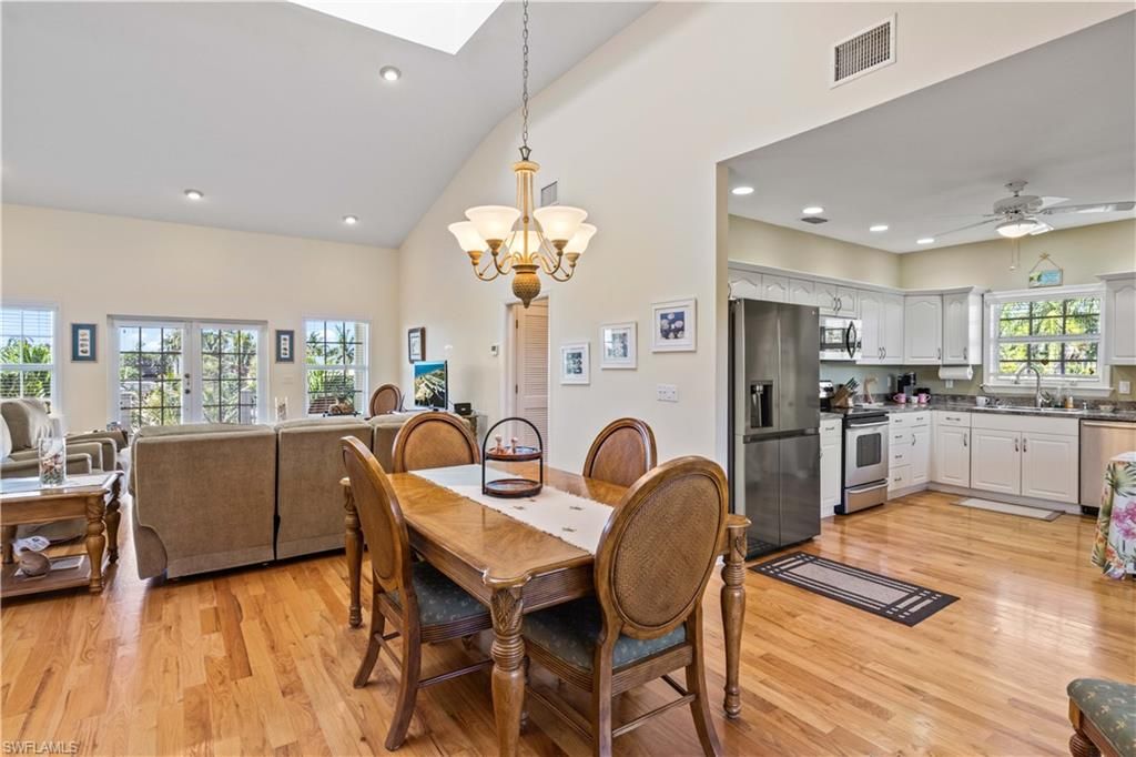 Chandelier, Dining room, Interior, Kitchen, Living room, Recessed Lighting, Stainless Steel Appliances, Wood Texture Flooring