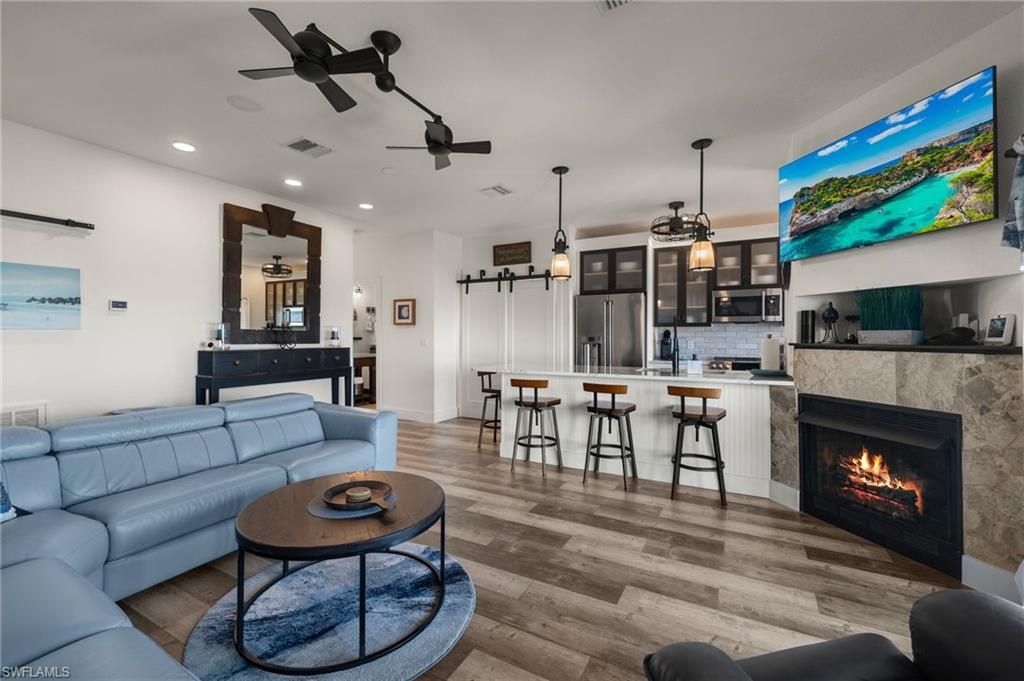 Fireplace, Interior, Kitchen, Living room, Pendant Lights, Recessed Lighting, Stainless Steel Appliances, Wood Texture Flooring