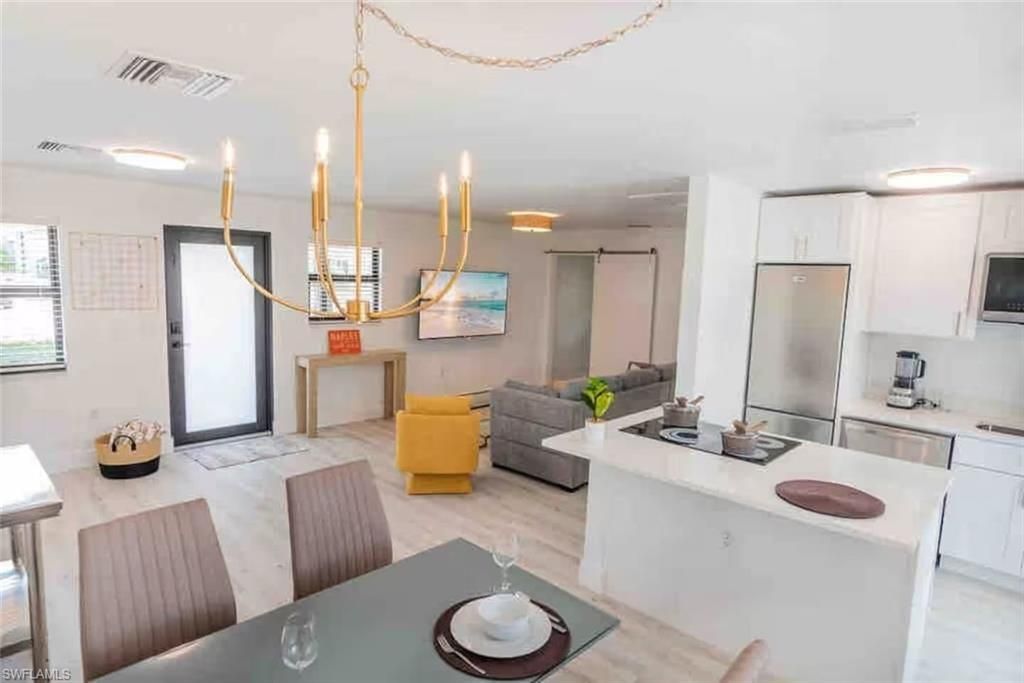 Chandelier, Dining room, Interior, Kitchen, Living room, Pendant Lights, Stainless Steel Appliances, Wood Texture Flooring