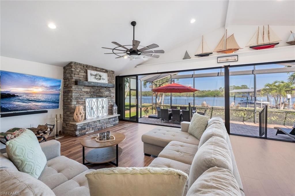 Fireplace, Interior, Living room, Recessed Lighting, Stone Walls, Water, Wood Texture Flooring