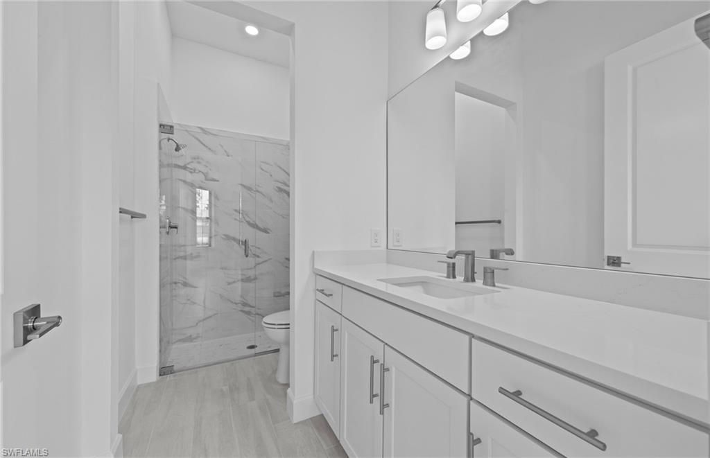 Bathroom, Glass Shower, Interior, Marble Walls, Recessed Lighting, Wood Texture Flooring