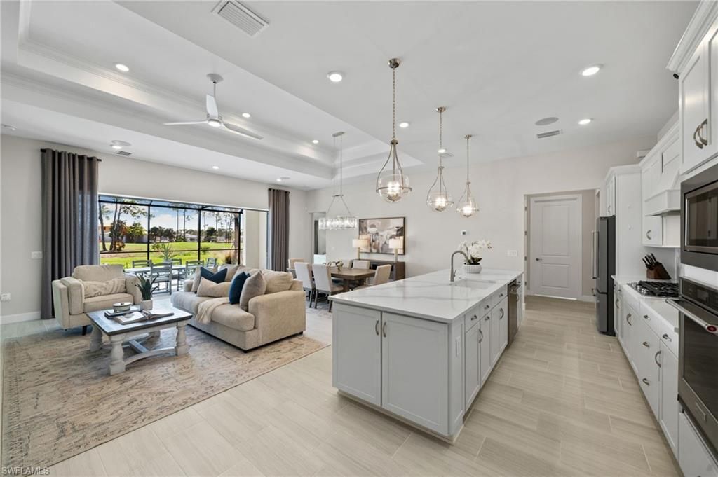 Chandelier, Dining room, Interior, Kitchen, Living room, Pendant Lights, Recessed Lighting, Stainless Steel Appliances, Wood Texture Flooring