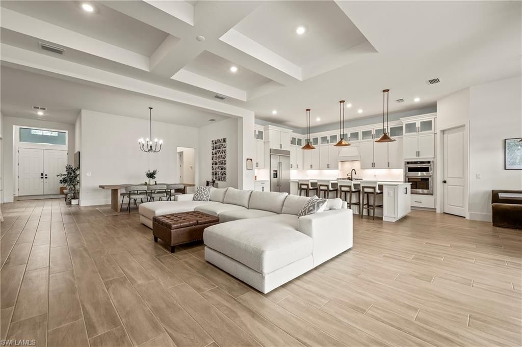 Chandelier, Dining room, Interior, Kitchen, Living room, Pendant Lights, Recessed Lighting, Stainless Steel Appliances, Wood Texture Flooring