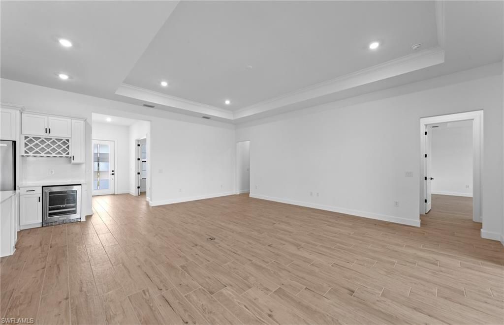 Empty room, Interior, Kitchen, Recessed Lighting, Stainless Steel Appliances, Wood Texture Flooring