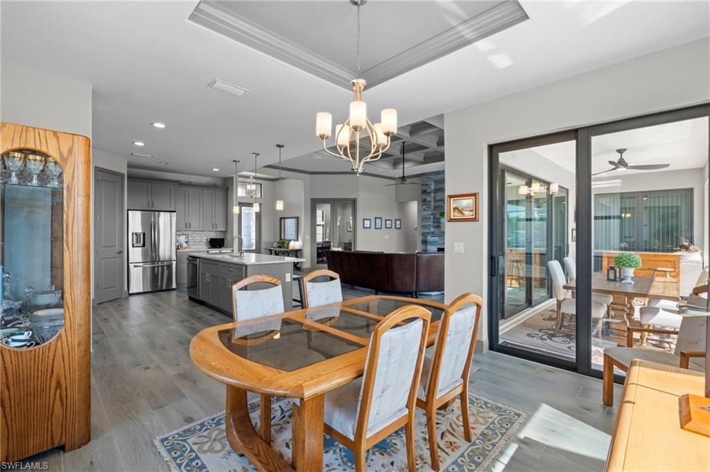 Chandelier, Dining room, Interior, Kitchen, Pendant Lights, Recessed Lighting, Stainless Steel Appliances, Wood Texture Flooring