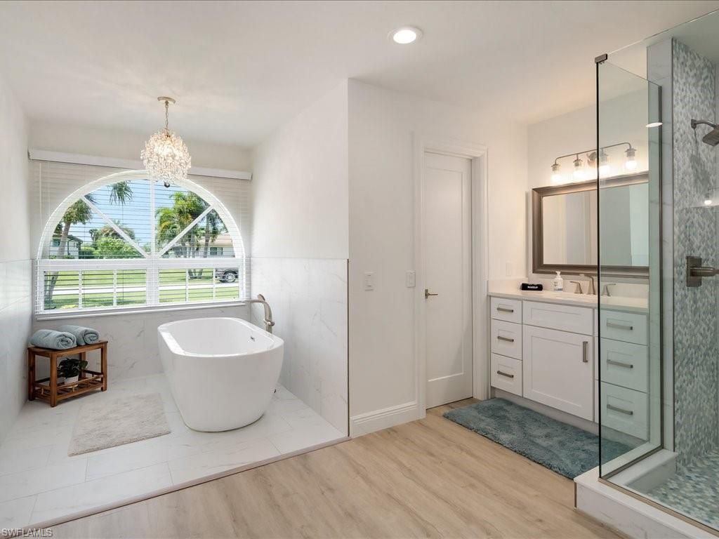 Bathroom, Chandelier, Free Standing Baths, Glass Shower, Interior, Recessed Lighting, Wood Texture Flooring