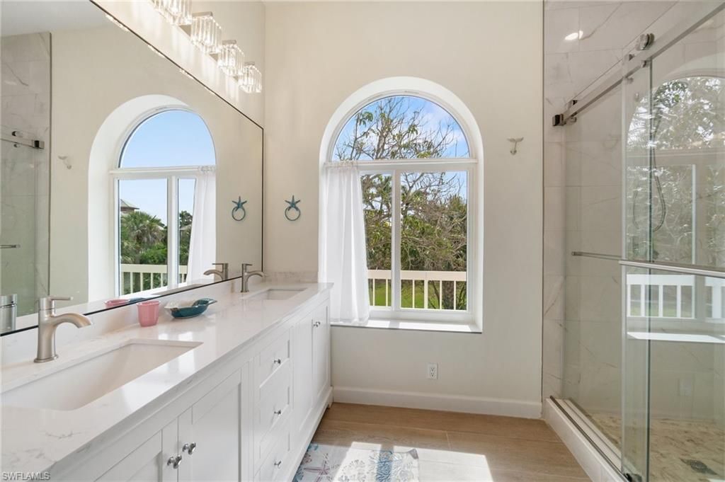 Bathroom, Dual Sink Vanities, Glass Shower, Interior, Marble Walls, Wood Texture Flooring