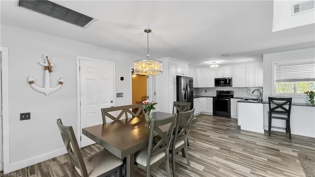 Chandelier, Dining room, Interior, Kitchen, Pendant Lights, Stainless Steel Appliances, Wood Texture Flooring