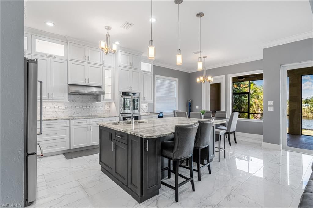 Chandelier, Dining room, Interior, Kitchen, Marble, Pendant Lights, Recessed Lighting, Stainless Steel Appliances