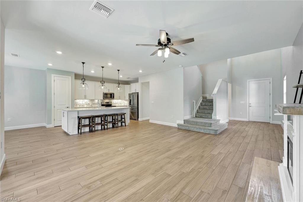 Fireplace, Interior, Kitchen, Pendant Lights, Recessed Lighting, Stainless Steel Appliances, Wood Texture Flooring