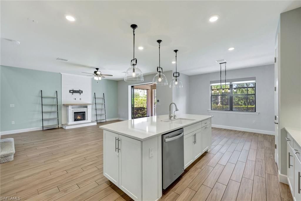 Empty room, Fireplace, Interior, Kitchen, Pendant Lights, Recessed Lighting, Wood Texture Flooring
