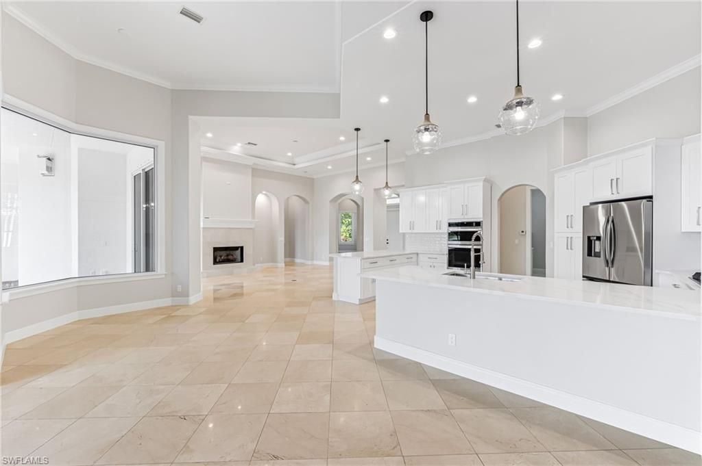 Empty room, Fireplace, Interior, Kitchen, Pendant Lights, Recessed Lighting, Stainless Steel Appliances