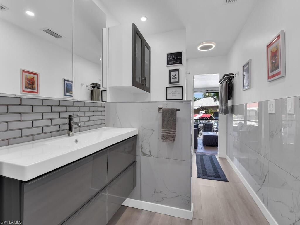 Bathroom, Glass Shower, Interior, Marble Walls, Recessed Lighting, Wood Texture Flooring