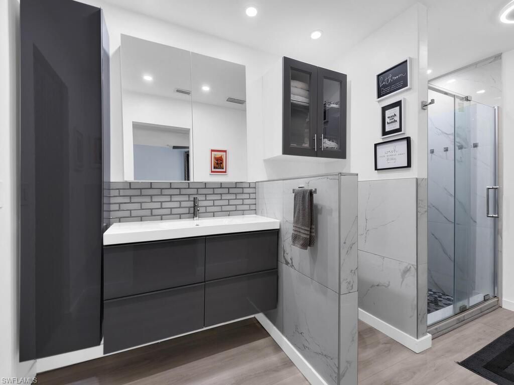 Bathroom, Glass Shower, Interior, Marble Walls, Recessed Lighting, Wood Texture Flooring