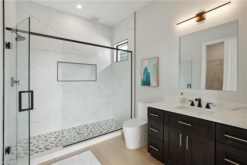Bathroom, Glass Shower, Interior, Marble Walls, Recessed Lighting, Wood Texture Flooring