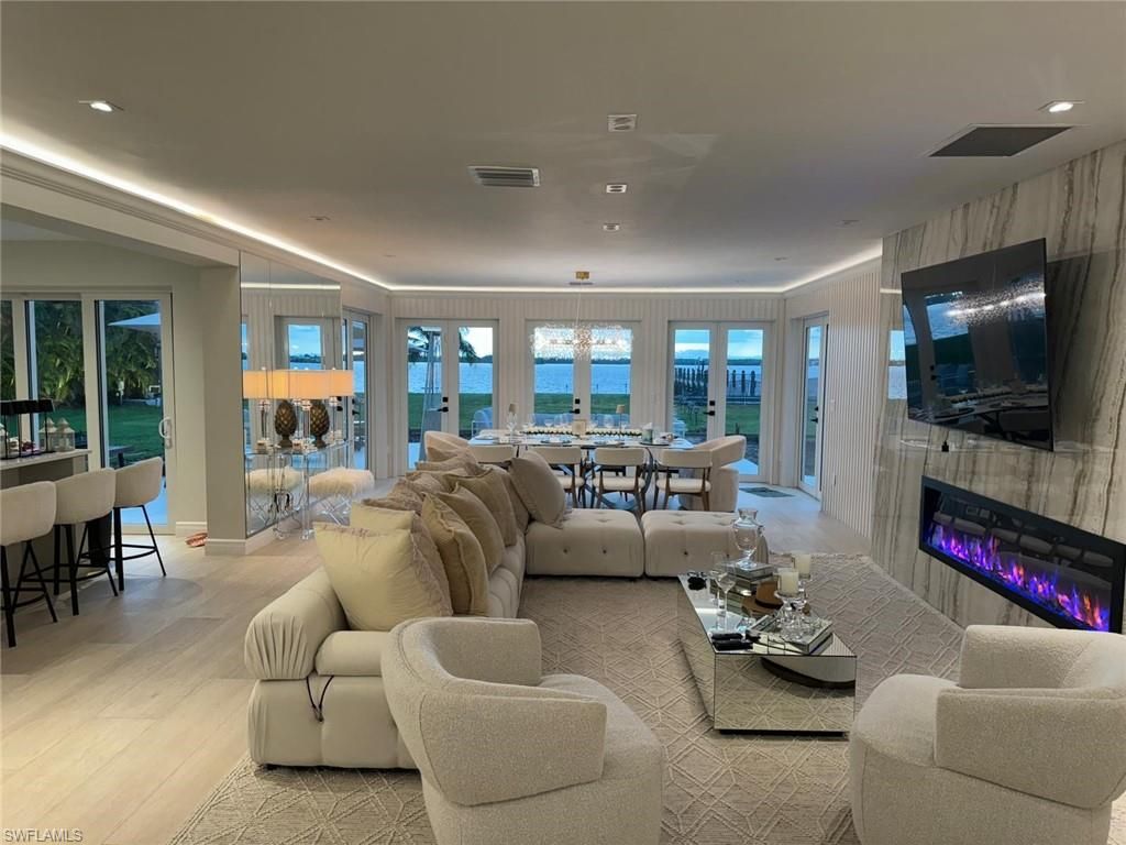 Dining room, Fireplace, Interior, Living room, Recessed Lighting, Water, Wood Texture Flooring