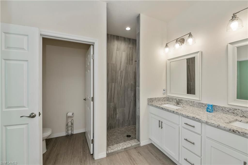 Bathroom, Dual Sink Vanities, Glass Shower, Interior, Recessed Lighting, Wood Texture Flooring