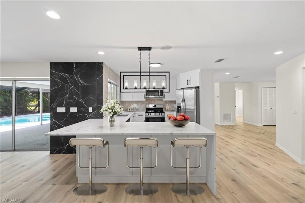 Interior, Kitchen, Marble Walls, Pendant Lights, Recessed Lighting, Stainless Steel Appliances, Wood Texture Flooring