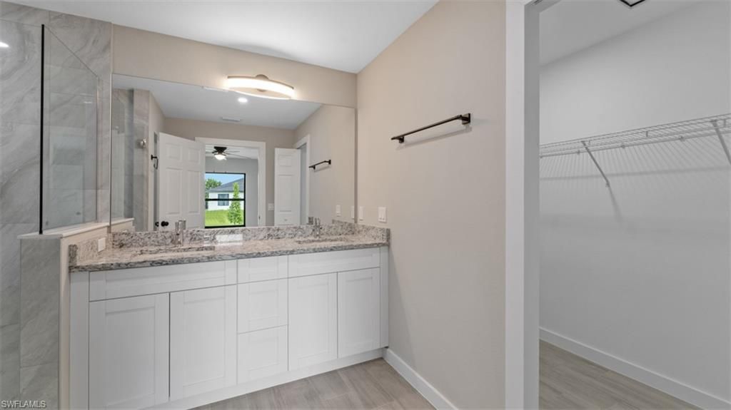Bathroom, Dual Sink Vanities, Glass Shower, Interior, Marble Walls, Wood Texture Flooring