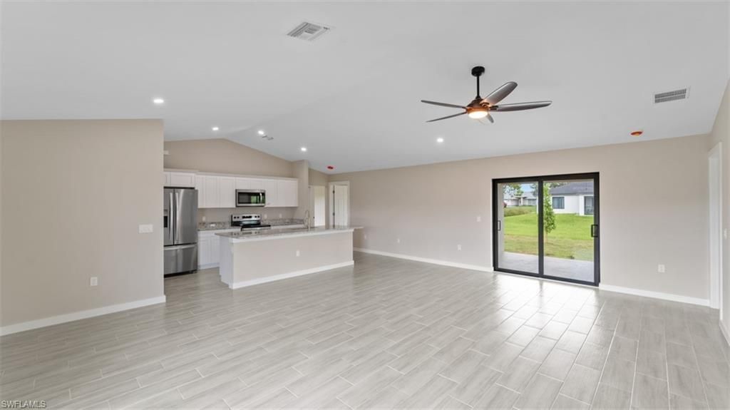 Empty room, Interior, Kitchen, Recessed Lighting, Stainless Steel Appliances, Wood Texture Flooring