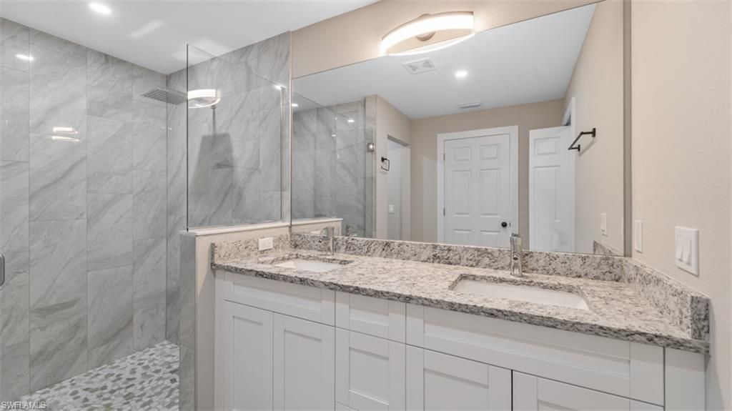 Bathroom, Dual Sink Vanities, Glass Shower, Interior, Marble Walls, Recessed Lighting
