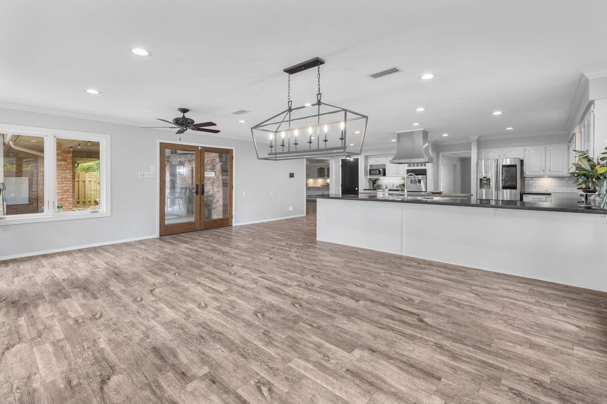 Chandelier, Empty room, Interior, Kitchen, Pendant Lights, Recessed Lighting, Stainless Steel Appliances, Wood Texture Flooring