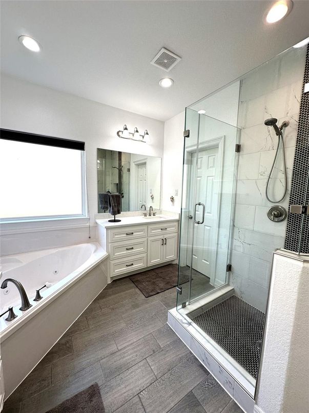 Bathroom, Dual Sink Vanities, Glass Shower, Interior, Marble Walls, Recessed Lighting, Wood Texture Flooring