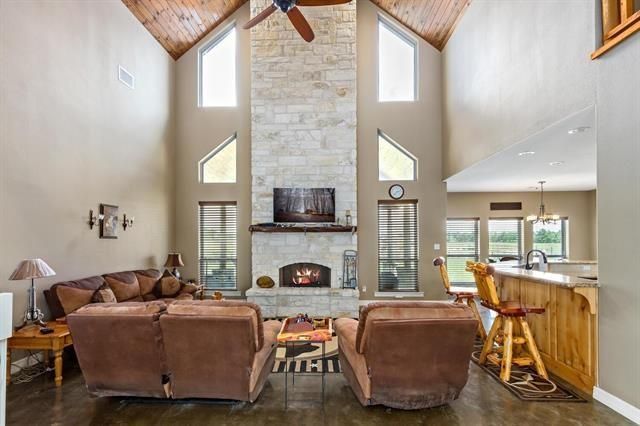 Chandelier, Dining room, Fireplace, Interior, Living room, Pendant Lights, Stone Walls, Wooden Ceilings