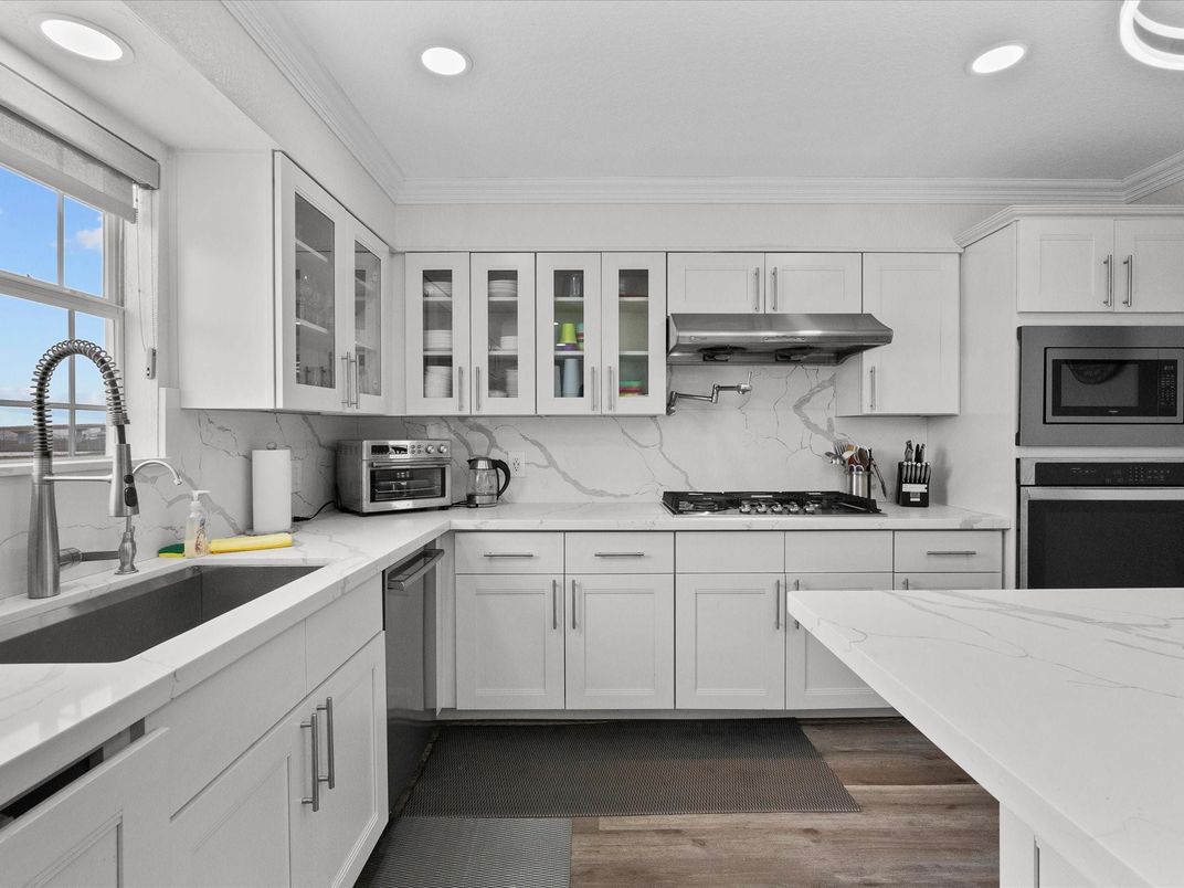 Interior, Kitchen, Marble Walls, Recessed Lighting, Stainless Steel Appliances, Wood Texture Flooring