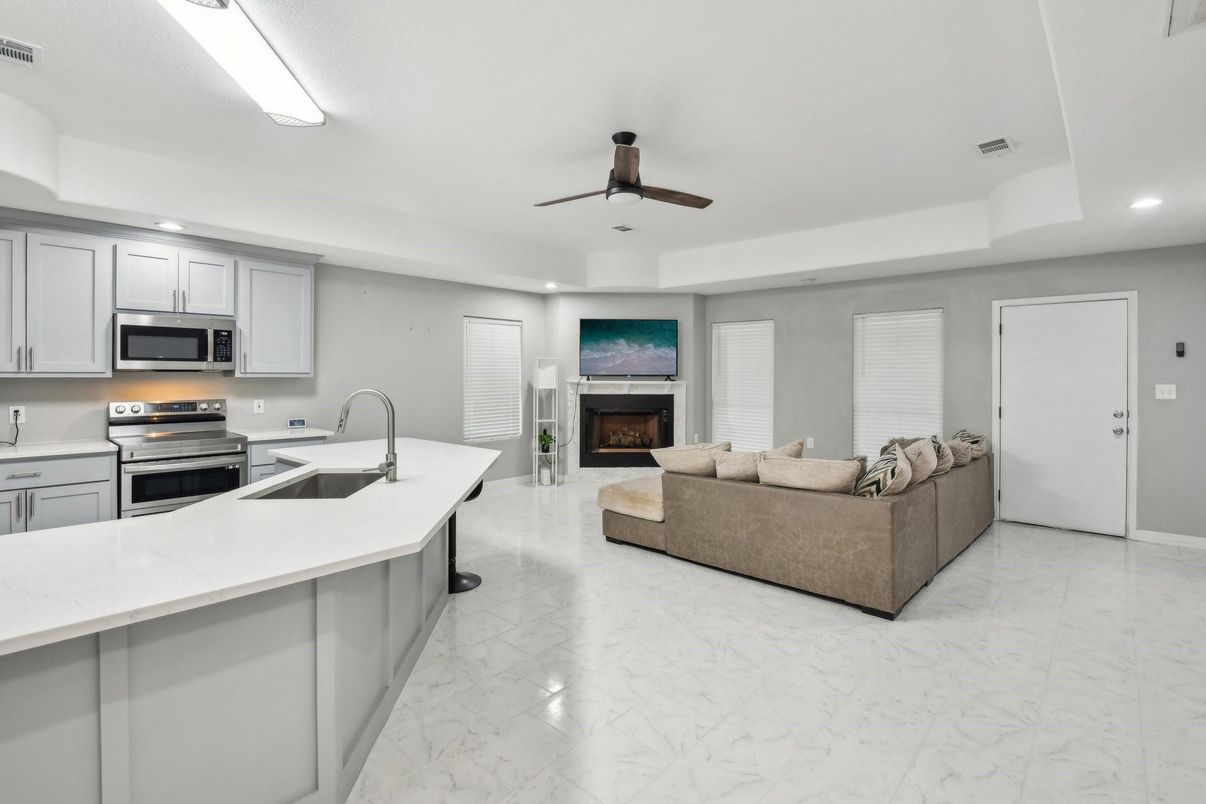 Fireplace, Interior, Kitchen, Living room, Marble, Recessed Lighting, Stainless Steel Appliances