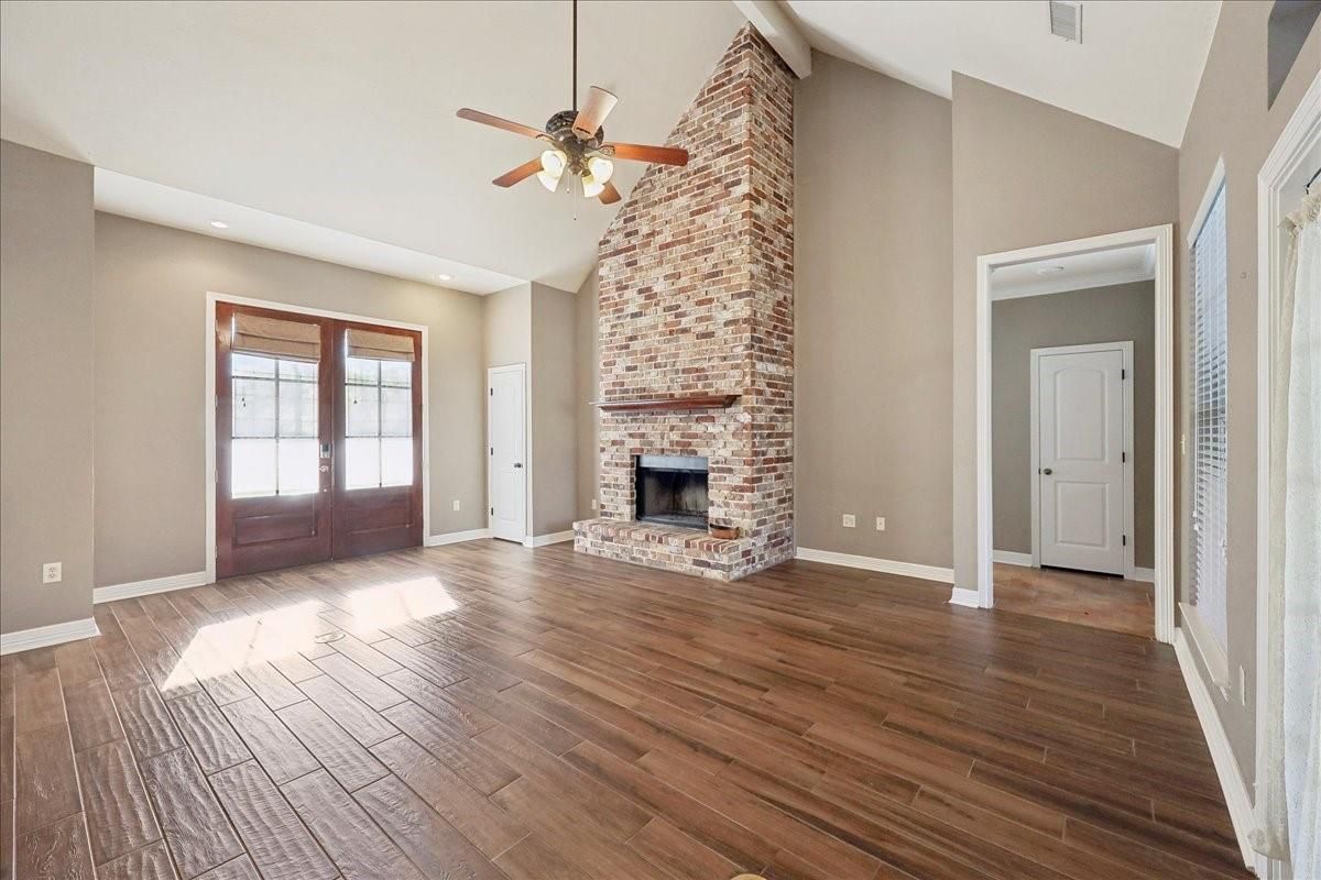 Empty room, Fireplace, Interior, Recessed Lighting, Stone Walls, Wood Texture Flooring