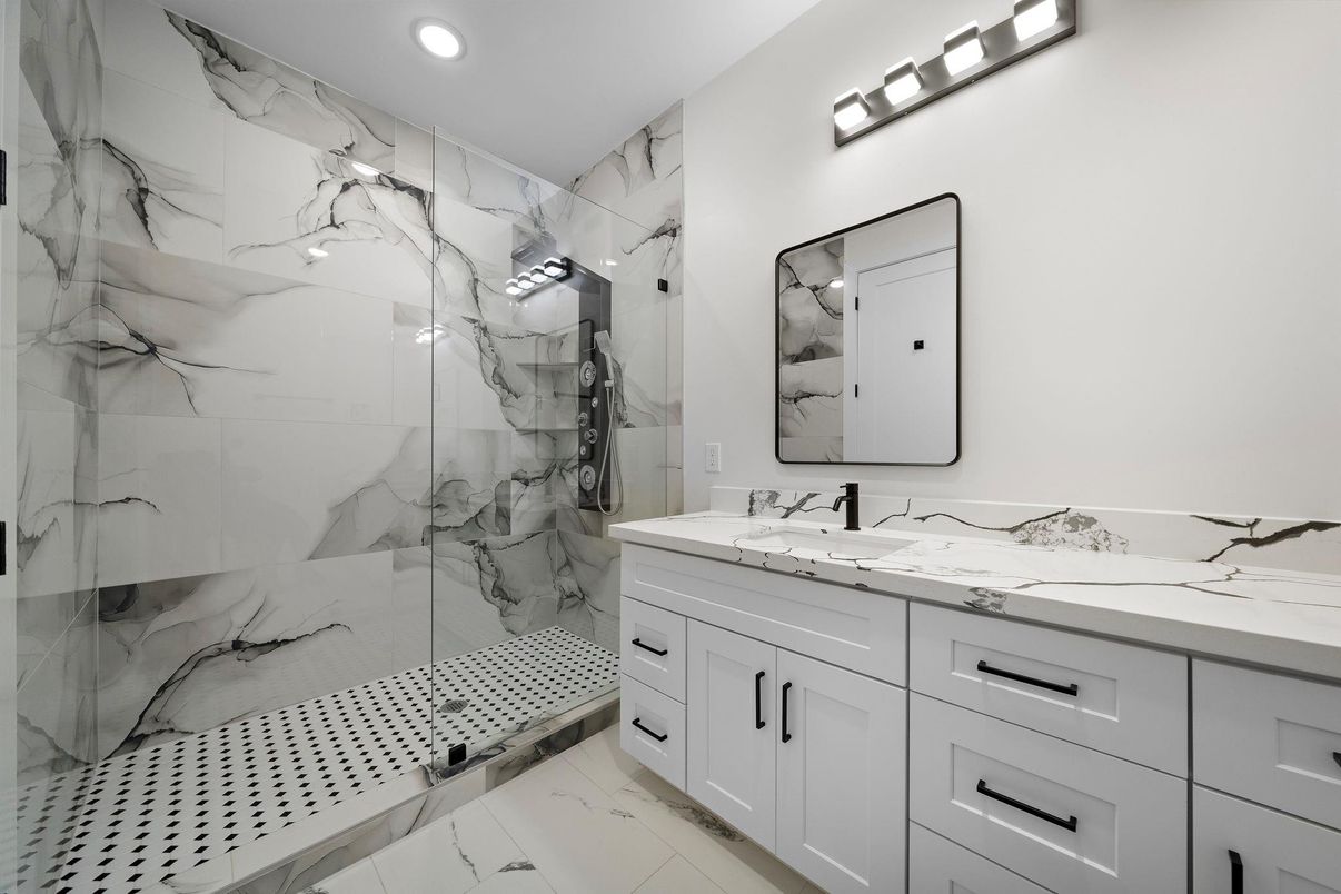 Bathroom, Dual Sink Vanities, Glass Shower, Interior, Marble, Marble Walls, Recessed Lighting