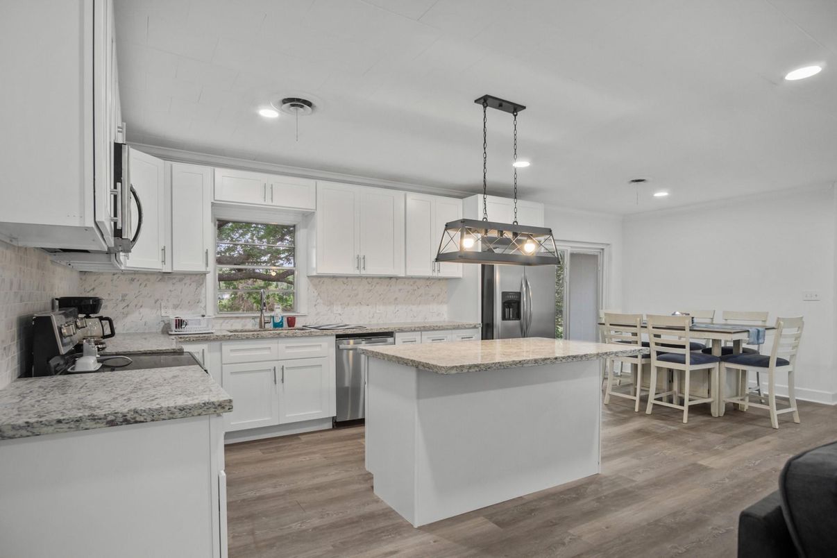 Dining room, Interior, Kitchen, Pendant Lights, Recessed Lighting, Stainless Steel Appliances, Wood Texture Flooring