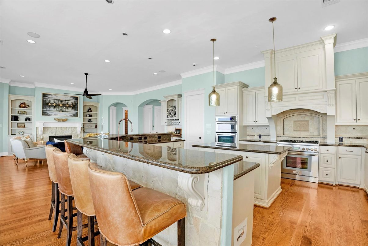 Fireplace, Interior, Kitchen, Living room, Pendant Lights, Recessed Lighting, Stainless Steel Appliances, Wood Texture Flooring